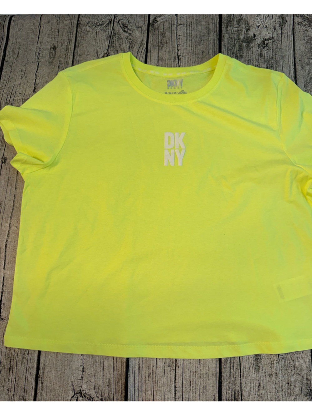 NEW. DKNY cropped work out tee. New, never used. Dry breathable fabric